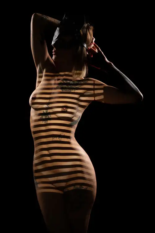A person's neck and shoulder are gently illuminated.
